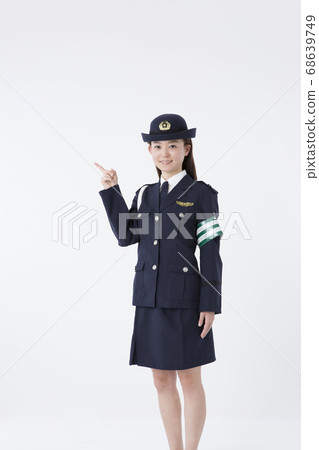 Female police officer pointing 68639749