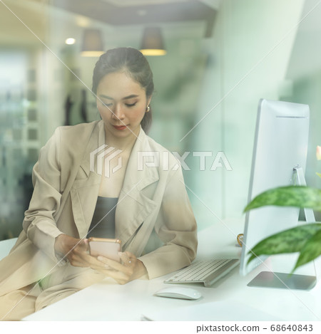 View through glass window of female entrepreneur 68640843