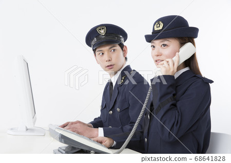 Police officer receiving a call Police officer receiving a call 68641828