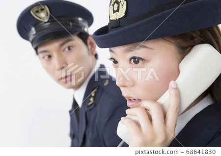 Police officer receiving a call Police officer receiving a call 68641830