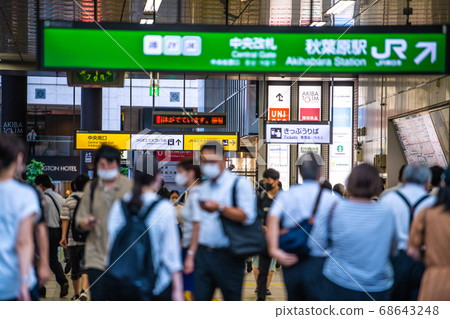 Tokyo cityscape, Japan: People wearing masks walking in front of Akihabara Station in the scorching heat on August 18th 68643248