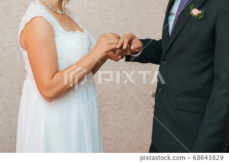 traditional wedding ceremony of exchange of gold rings between the bride and groom traditional wedding ceremony of exchange of gold rings between the bride and groom 68643829