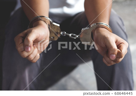 Handcuffed prisoner in jail 68646445