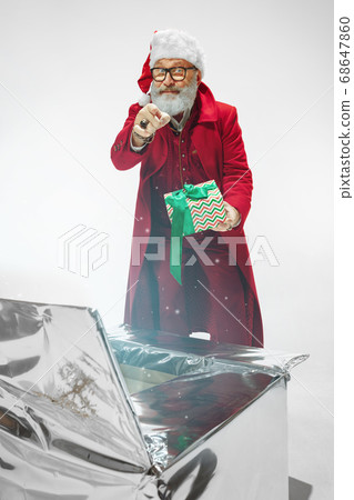 Modern stylish Santa Claus in red fashionable suit isolated on white background 68647860
