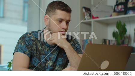 Man freelancer using laptop online working in internet, guy typing on computer surfing web looking at screen enjoying distant job. 68648005