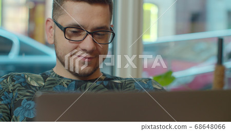 Man freelancer using laptop online working in internet, guy typing on computer surfing web looking at screen enjoying distant job. 68648066