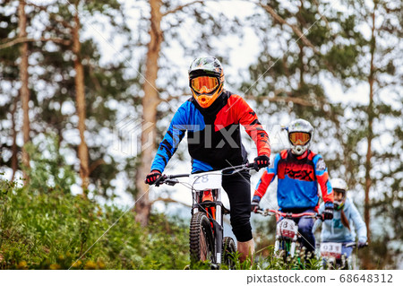 three rider athlete on downhill 68648312