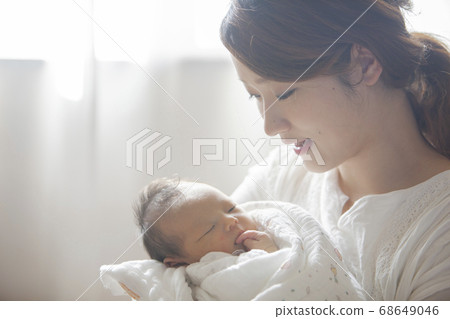 Mother holding a newborn baby Mother holding a newborn baby 68649046