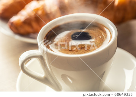 Cup of coffee and fresh croissants - italian or 68649335