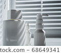 Still life with three blank white vials in sunlight on a windowsill 68649341