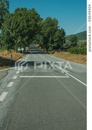 Road passing through rural landscape 68649404