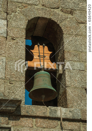 Medieval steeple made of stone bricks with bell 68649420
