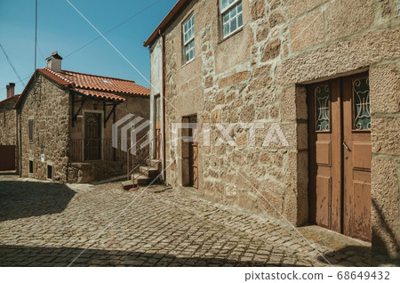Old houses with stone wall on deserted alley Old houses with stone wall on deserted alley 68649432