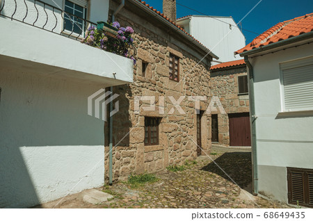 Houses with stone wall on narrow alley Houses with stone wall on narrow alley 68649435
