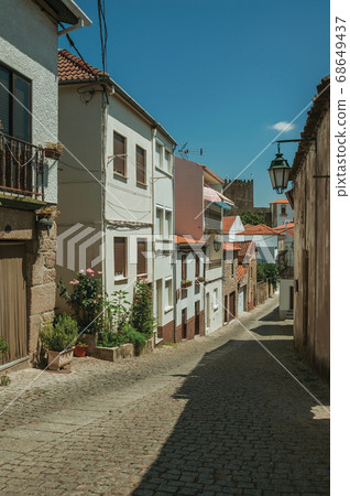 Old houses with flowering pots and deserted alley Old houses with flowering pots and deserted alley 68649437