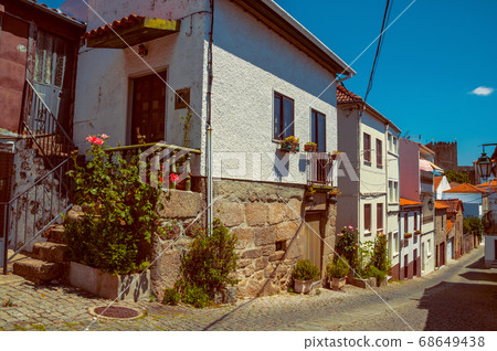 Old houses with flowering pots and deserted alley Old houses with flowering pots and deserted alley 68649438