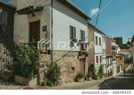 Old houses with flowering pots and deserted alley 68649439