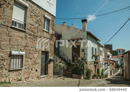 Old houses with flowering pots and deserted alley 68649440