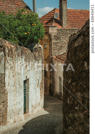 Narrow deserted alley with worn plaster walls Narrow deserted alley with worn plaster walls 68649451