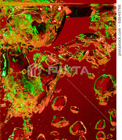 Close up view of the cold and fresh cola with bright bubbles in neon light Close up view of the cold and fresh cola with bright bubbles in neon light 68649766