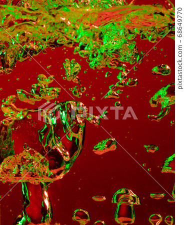 Close up view of the cold and fresh cola with bright bubbles in neon light Close up view of the cold and fresh cola with bright bubbles in neon light 68649770