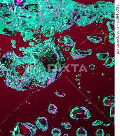 Close up view of the cold and fresh cola with bright bubbles in neon light Close up view of the cold and fresh cola with bright bubbles in neon light 68649782