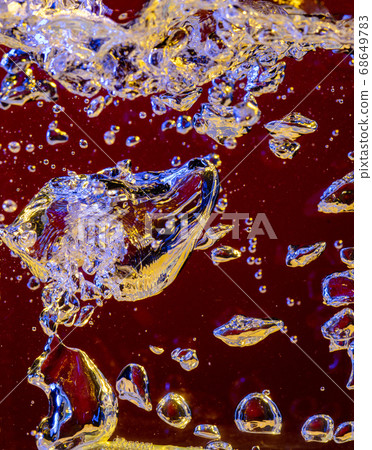 Close up view of the cold and fresh cola with bright bubbles in neon light 68649783