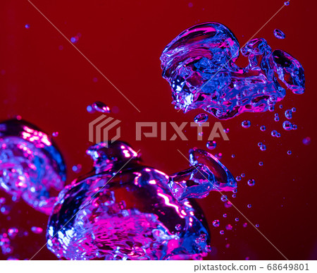 Close up view of the cold and fresh cola with bright bubbles in neon light Close up view of the cold and fresh cola with bright bubbles in neon light 68649801
