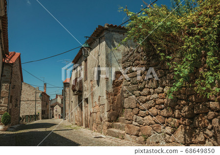 Old house made of stone on deserted alley Old house made of stone on deserted alley 68649850