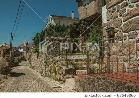 Narrow deserted alley and old houses Narrow deserted alley and old houses 68649860