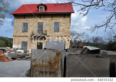 derelict stone house and pile of box crates derelict stone house and pile of box crates 68650182