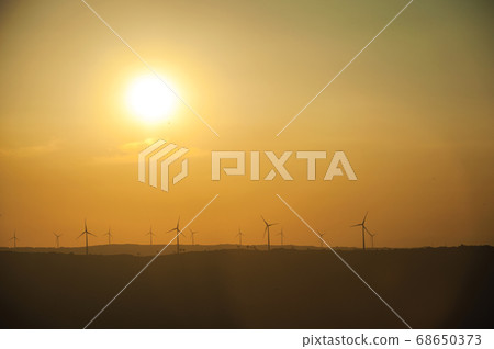Landscape and several wind turbines silhouettes on sunset 68650373