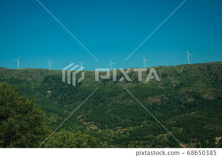 Wind turbines for electric power generation on hill Wind turbines for electric power generation on hill 68650385
