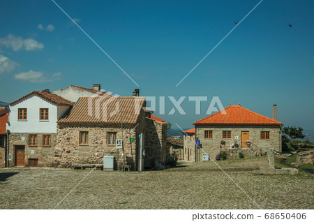 Old rustic houses made of stone in front of square Old rustic houses made of stone in front of square 68650406