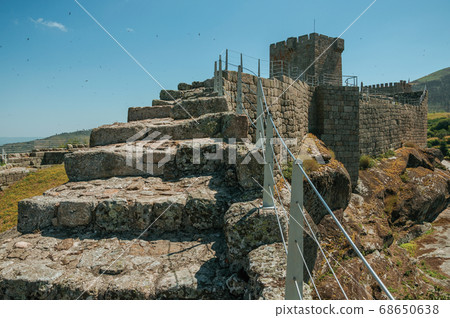Path with steps over stone wall with balustrade Path with steps over stone wall with balustrade 68650638