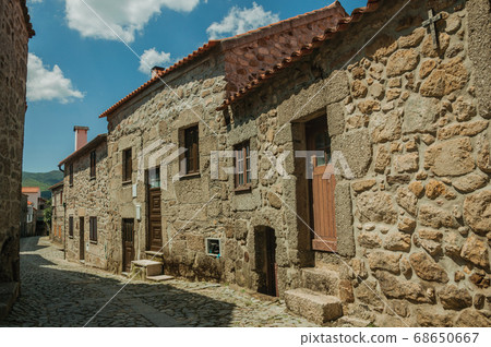 Old houses made of stone on cobblestone alley Old houses made of stone on cobblestone alley 68650667