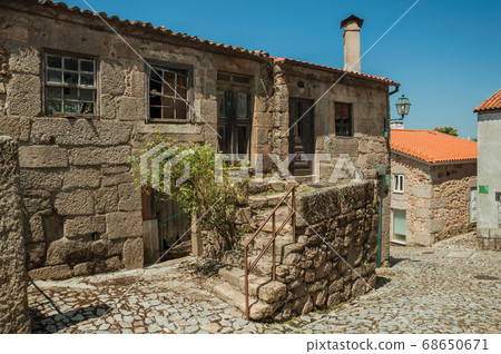 Old houses and stone staircase on cobblestone alley 68650671