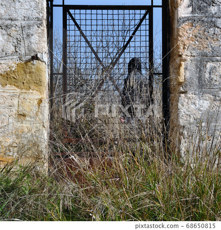 man behind vintage metal door 68650815