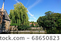 A blue sky spread over Bruges full of greenery 68650823