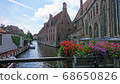 Bruges, the City of Waters, a historic building facing the river 68650826
