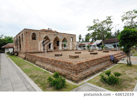 PATTANI, THAILAND -JULY 10, 2014: Historic Kru Se mosque which is made of bricks with round pillars. The mosque represents a unique Islamic civilization of the Kingdom of Pattani in Thailand. 68652039