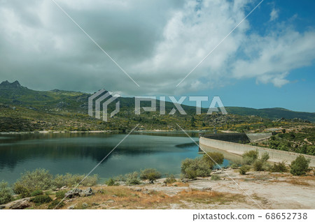Rocky shore next to the concrete dam of Rossim Lake 68652738