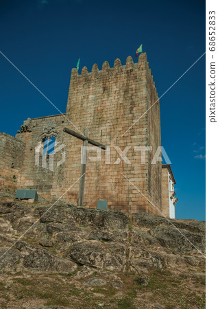 Castle and square tower over rocky hill with cross Castle and square tower over rocky hill with cross 68652833