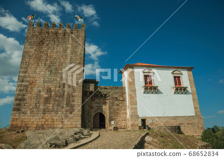 Castle and square tower over rocky hill Castle and square tower over rocky hill 68652834
