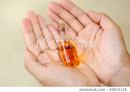 Hands holding CBD oil. Alternative Medicine, Herbal Treatment concept Hands holding CBD oil. Alternative Medicine, Herbal Treatment concept 68653126