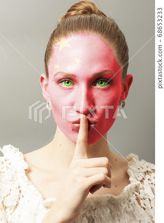 Young woman making a silence gesture with China 68653233