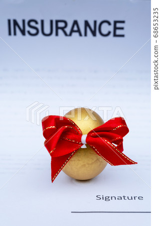 Golden Egg with red Ribbon isolated on insurance contract background 68653235
