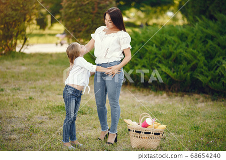 Mother with daughter playing in a summer paek 68654240
