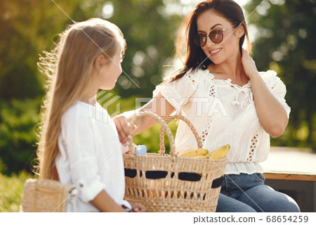 Mother with daughter playing in a summer paek Mother with daughter playing in a summer paek 68654259