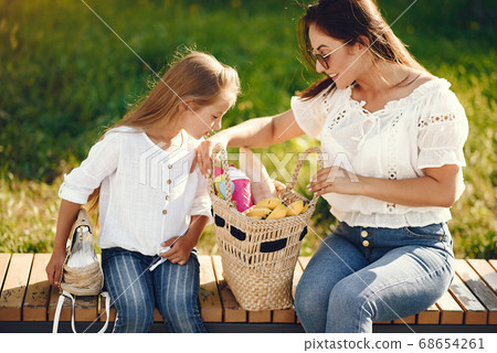 Mother with daughter playing in a summer paek Mother with daughter playing in a summer paek 68654261